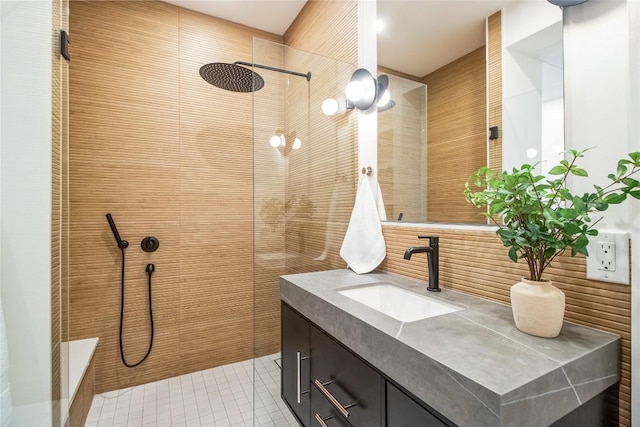 700 Denson Dr Unit 1104, Austin, TX 78752 - full bathroom featuring a tile shower, vanity, and tile patterned flooring