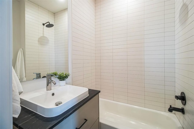 700 Denson Dr Unit 1104, Austin, TX 78752 - bathroom featuring shower / washtub combination, vanity, and tile walls