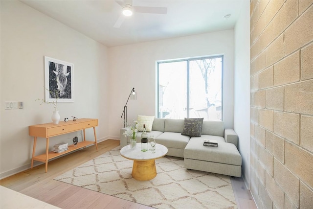 700 Denson Dr Unit 1104, Austin, TX 78752 - living room featuring a ceiling fan, light wood-style flooring, and baseboards