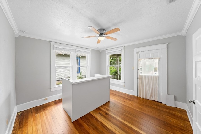 2032 E Cesar Chavez St, Austin, TX 78702 - spare room featuring ornamental molding, hardwood / wood-style floors, a textured ceiling, baseboards, and ceiling fan