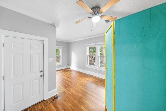 2032 E Cesar Chavez St, Austin, TX 78702 - foyer entrance featuring hardwood / wood-style floors, ornamental molding, baseboards, ceiling fan, and a textured ceiling