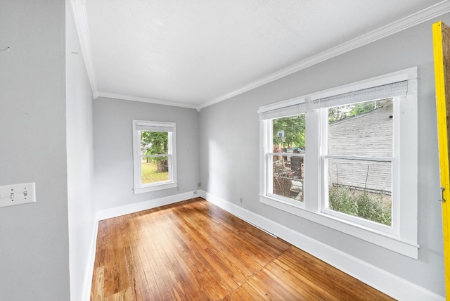 2032 E Cesar Chavez St, Austin, TX 78702 - unfurnished room featuring crown molding, baseboards, and wood-type flooring