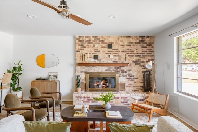 304 W Bee St, Lockhart, TX 78644 - living area featuring a ceiling fan, a brick fireplace, baseboards, wood finished floors, and recessed lighting
