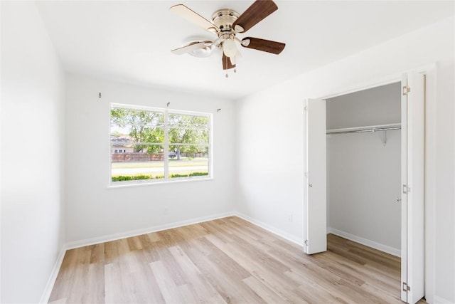304 W Bee St, Lockhart, TX 78644 - unfurnished bedroom with light wood-type flooring, baseboards, a closet, and ceiling fan