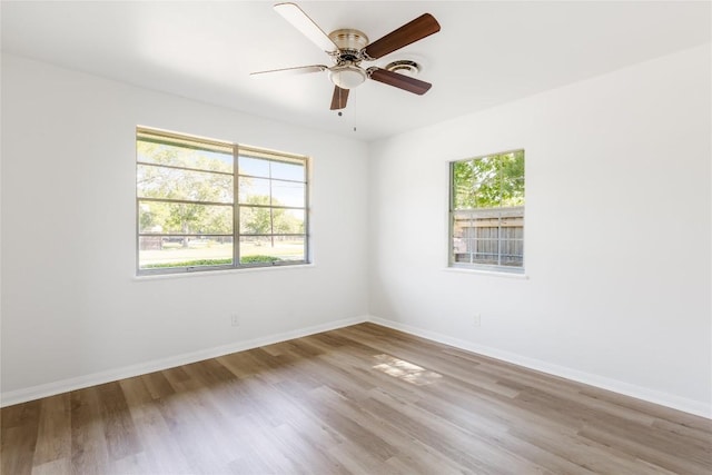 304 W Bee St, Lockhart, TX 78644 - empty room featuring wood finished floors, baseboards, and ceiling fan