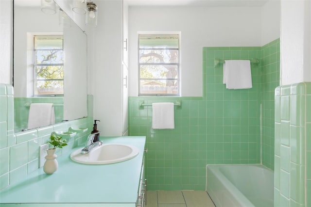 304 W Bee St, Lockhart, TX 78644 - bathroom featuring tile walls, vanity, and tile patterned floors