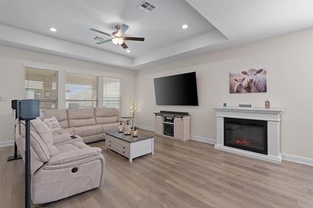 3227 Drago Dr, Round Rock, TX 78665 - living area featuring ceiling fan, light wood-type flooring, recessed lighting, baseboards, and a raised ceiling