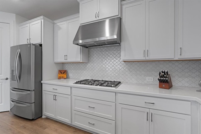 3227 Drago Dr, Round Rock, TX 78665 - kitchen with stainless steel appliances, under cabinet range hood, light countertops, light wood finished floors, and white cabinets