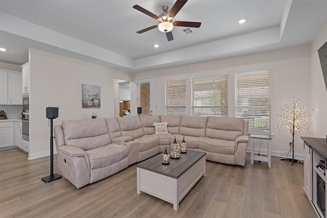 3227 Drago Dr, Round Rock, TX 78665 - living area with a ceiling fan, light wood-style floors, a raised ceiling, recessed lighting, and baseboards