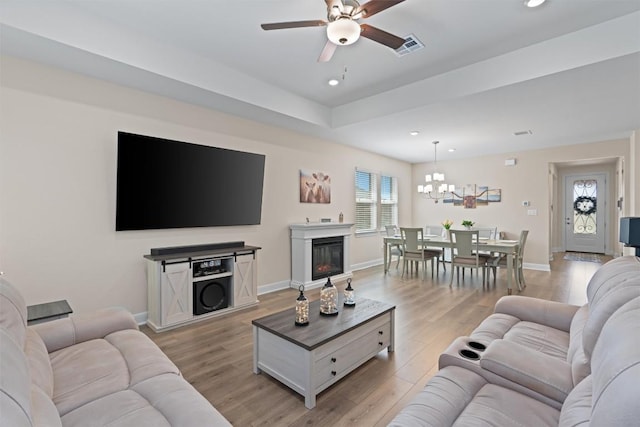 3227 Drago Dr, Round Rock, TX 78665 - living room featuring a ceiling fan, light wood finished floors, recessed lighting, baseboards, and a chandelier