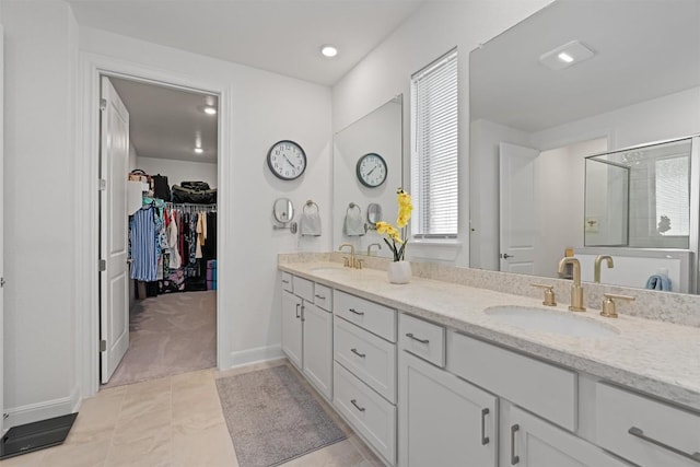 3227 Drago Dr, Round Rock, TX 78665 - full bathroom with a stall shower, double vanity, a spacious closet, baseboards, and recessed lighting