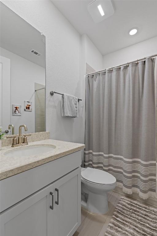 3227 Drago Dr, Round Rock, TX 78665 - bathroom with toilet, vanity, tile patterned flooring, and curtained shower
