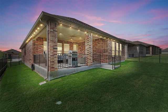 3227 Drago Dr, Round Rock, TX 78665 - back of property at dusk featuring a patio area and brick siding