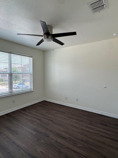 5511 Toledo Farm, San Antonio, TX 78222 - empty room with dark wood-type flooring, baseboards, and ceiling fan