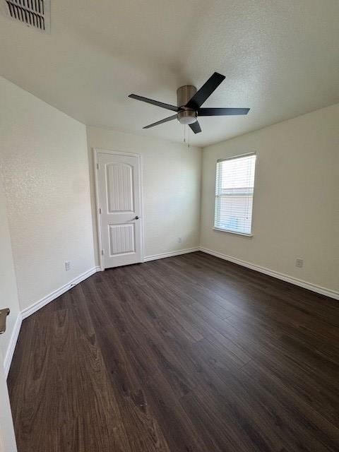 5511 Toledo Farm, San Antonio, TX 78222 - empty room with dark wood-style floors, ceiling fan, and baseboards
