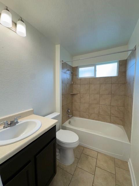 5511 Toledo Farm, San Antonio, TX 78222 - bathroom featuring tile patterned flooring, vanity, bathtub / shower combination, and toilet