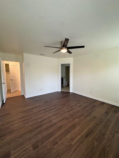 5511 Toledo Farm, San Antonio, TX 78222 - unfurnished room featuring ceiling fan, baseboards, and dark wood finished floors