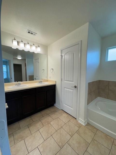 5511 Toledo Farm, San Antonio, TX 78222 - full bathroom with tile patterned floors, double vanity, a bath, and baseboards