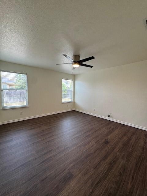 5511 Toledo Farm, San Antonio, TX 78222 - unfurnished room with dark wood-style flooring, baseboards, and a ceiling fan
