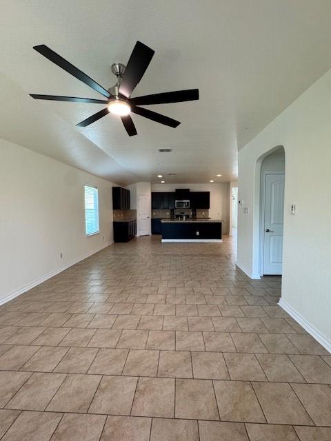 5511 Toledo Farm, San Antonio, TX 78222 - unfurnished living room with a ceiling fan, baseboards, arched walkways, and recessed lighting
