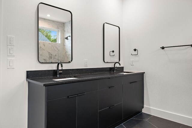 1711 E M Franklin Ave Unit 1, Austin, TX 78721 - bathroom featuring tile patterned floors, double vanity, and baseboards