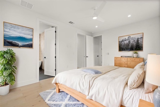 1711 E M Franklin Ave Unit 1, Austin, TX 78721 - bedroom featuring wood finished floors, recessed lighting, ensuite bathroom, ceiling fan, and baseboards