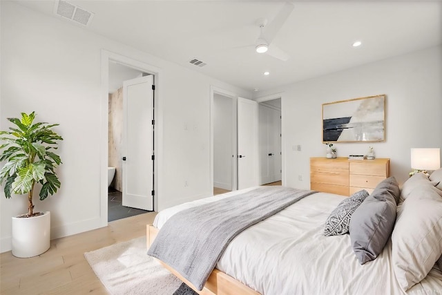 1711 E M Franklin Ave Unit 1, Austin, TX 78721 - bedroom with recessed lighting, wood finished floors, baseboards, ensuite bath, and a ceiling fan