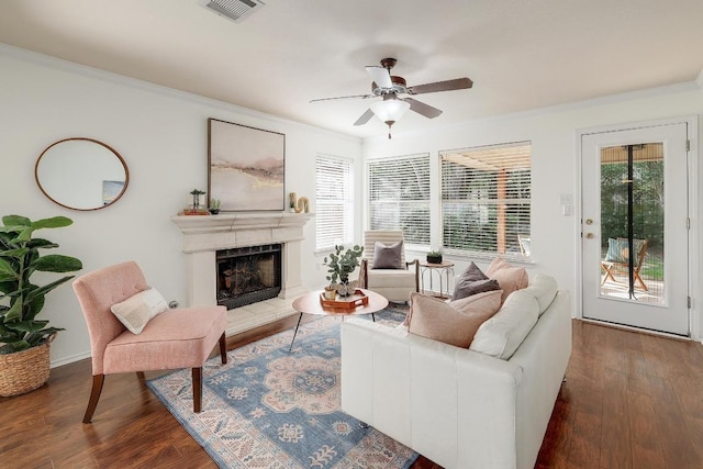 13413 Bolivia Dr, Austin, TX 78729 - living area with crown molding, wood finished floors, a ceiling fan, and a fireplace with raised hearth