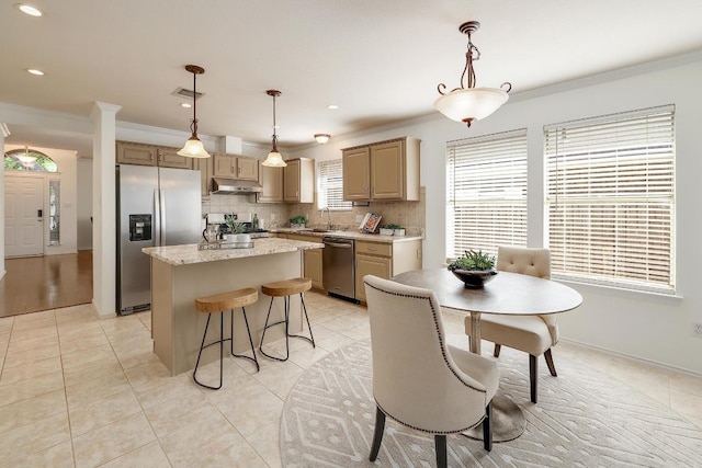 13413 Bolivia Dr, Austin, TX 78729 - kitchen with stainless steel appliances, a kitchen island, crown molding, under cabinet range hood, and decorative backsplash