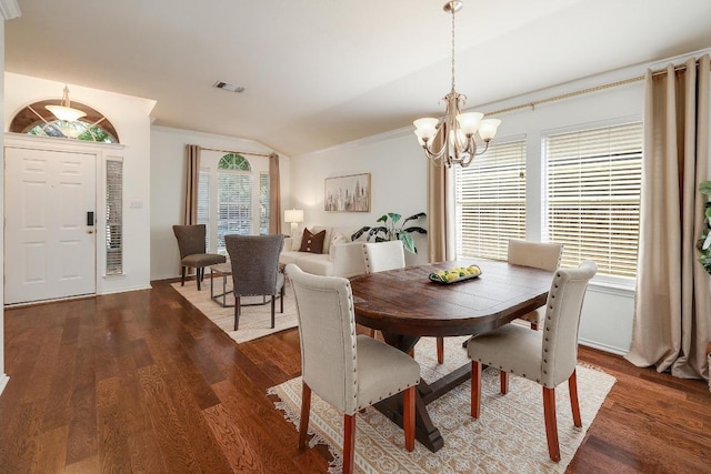 13413 Bolivia Dr, Austin, TX 78729 - dining space featuring a chandelier, dark wood-type flooring, lofted ceiling, crown molding, and baseboards