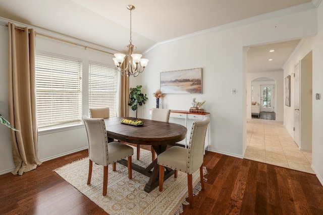 13413 Bolivia Dr, Austin, TX 78729 - dining room with a chandelier, arched walkways, crown molding, baseboards, and wood finished floors