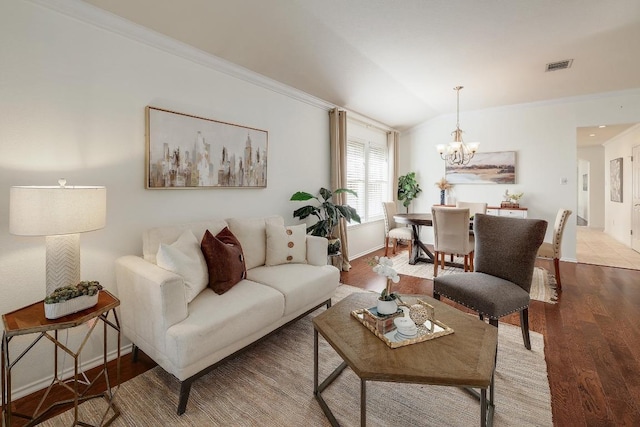 13413 Bolivia Dr, Austin, TX 78729 - living area with a chandelier, wood finished floors, lofted ceiling, crown molding, and baseboards