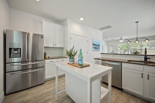206 Skinner, Kyle, TX 78640 - kitchen with stainless steel appliances, a sink, decorative backsplash, white cabinets, and recessed lighting