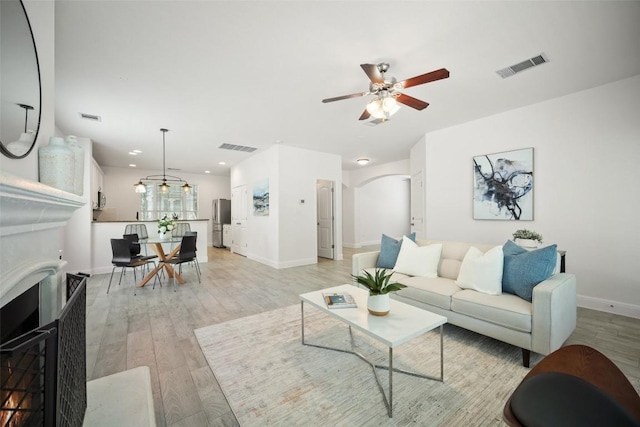 206 Skinner, Kyle, TX 78640 - living room with a ceiling fan, arched walkways, light wood-type flooring, baseboards, and recessed lighting