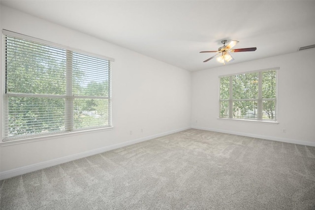 206 Skinner, Kyle, TX 78640 - unfurnished room with healthy amount of natural light, a ceiling fan, carpet, and baseboards