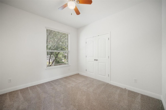 206 Skinner, Kyle, TX 78640 - unfurnished bedroom with carpet floors, baseboards, a closet, and a ceiling fan