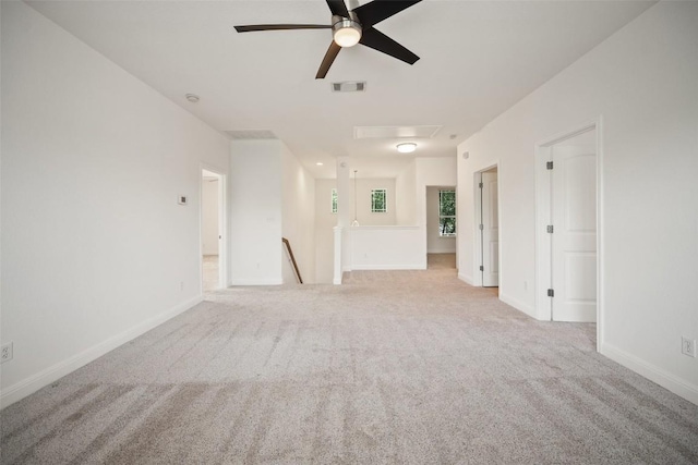 206 Skinner, Kyle, TX 78640 - unfurnished living room with carpet, a ceiling fan, baseboards, and attic access