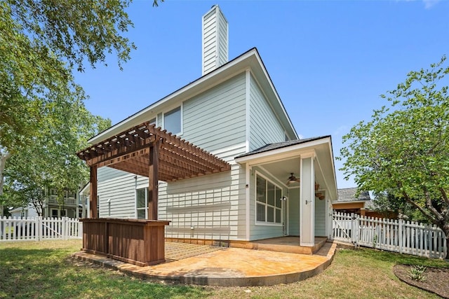 206 Skinner, Kyle, TX 78640 - rear view of property with a ceiling fan, a pergola, and a chimney