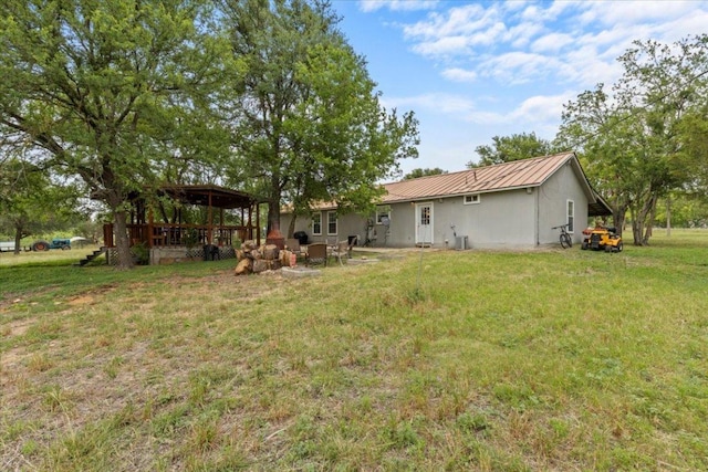 7406 Nez Perce Trce, Manor, TX 78653 - rear view of property featuring a yard, metal roof, and a gazebo