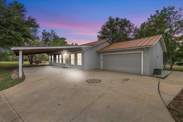 7406 Nez Perce Trce, Manor, TX 78653 - view of front facade featuring driveway, metal roof, and a standing seam roof