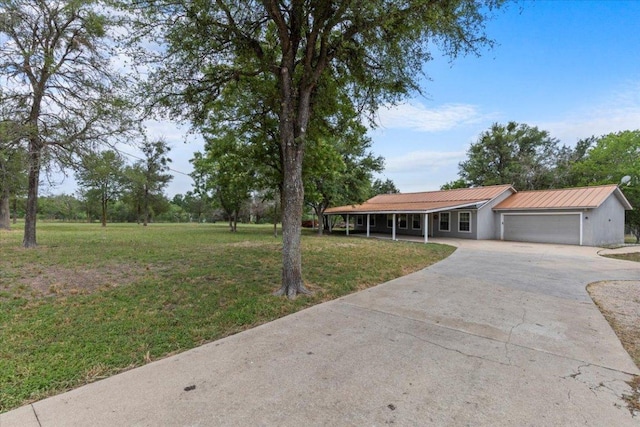 7406 Nez Perce Trce, Manor, TX 78653 - view of front facade featuring a front lawn, concrete driveway, an attached garage, and metal roof