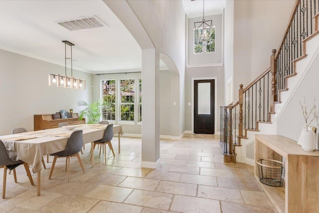 11316 Woodland Hills Trl, Austin, TX 78732 - foyer with arched walkways, stone tile floors, baseboards, stairway, and crown molding