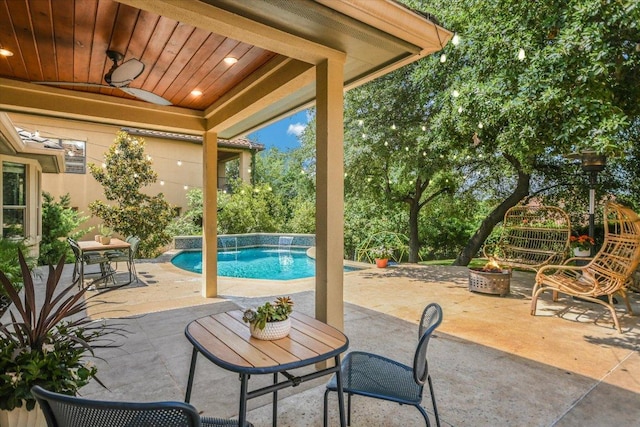 11316 Woodland Hills Trl, Austin, TX 78732 - view of patio featuring an outdoor fire pit, a ceiling fan, and an outdoor pool
