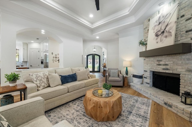 7 Sunview Rd, The Hills, TX 78738 - living room featuring arched walkways, wood finished floors, healthy amount of natural light, crown molding, and recessed lighting