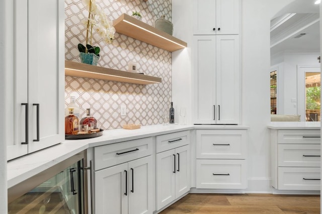 7 Sunview Rd, The Hills, TX 78738 - kitchen featuring open shelves, light countertops, white cabinets, crown molding, and backsplash