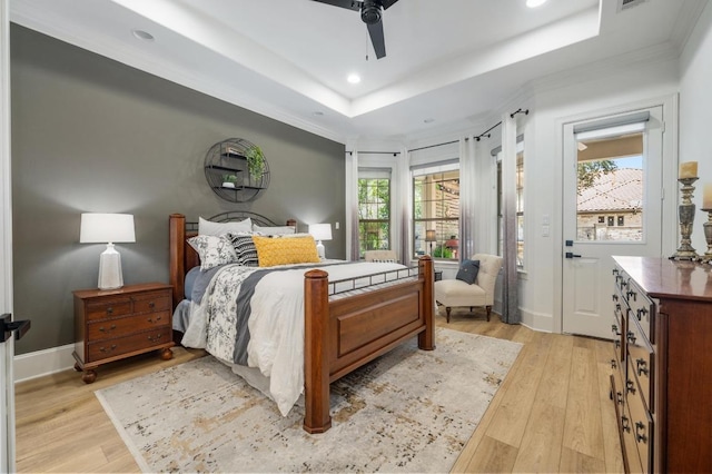 7 Sunview Rd, The Hills, TX 78738 - bedroom with light wood-type flooring, recessed lighting, a tray ceiling, crown molding, and ceiling fan