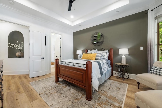 7 Sunview Rd, The Hills, TX 78738 - bedroom with light wood-type flooring, baseboards, a raised ceiling, recessed lighting, and a ceiling fan