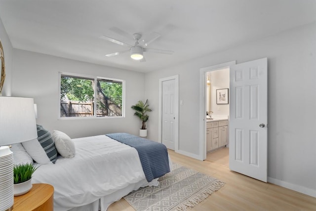 902 Acorn Oaks Dr, Austin, TX 78745 - bedroom with light wood-style flooring, ensuite bath, and ceiling fan