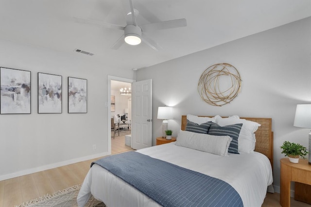 902 Acorn Oaks Dr, Austin, TX 78745 - bedroom featuring light wood-style flooring, a chandelier, and a ceiling fan