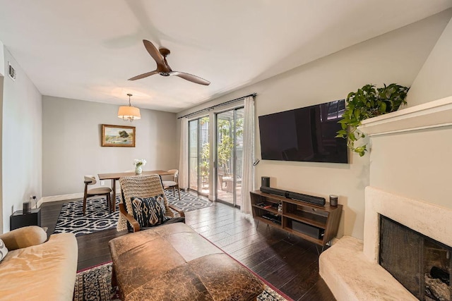 606 W Lynn St Unit 16, Austin, TX 78703 - living area with ceiling fan, hardwood / wood-style floors, a fireplace, and baseboards